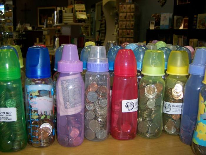 A child has a bottle full of pennies